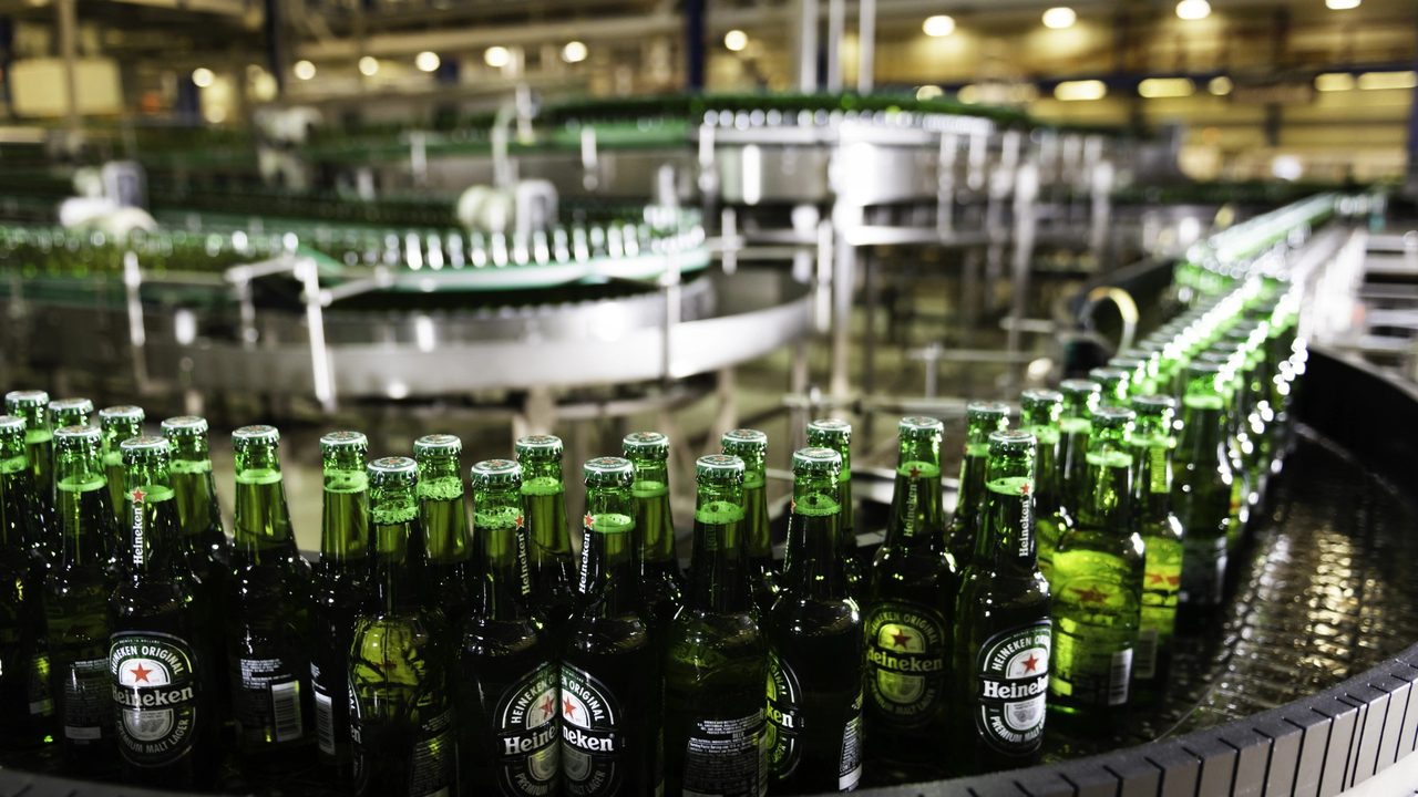 Volle flessen op de transportband in een brouwerij van Heineken